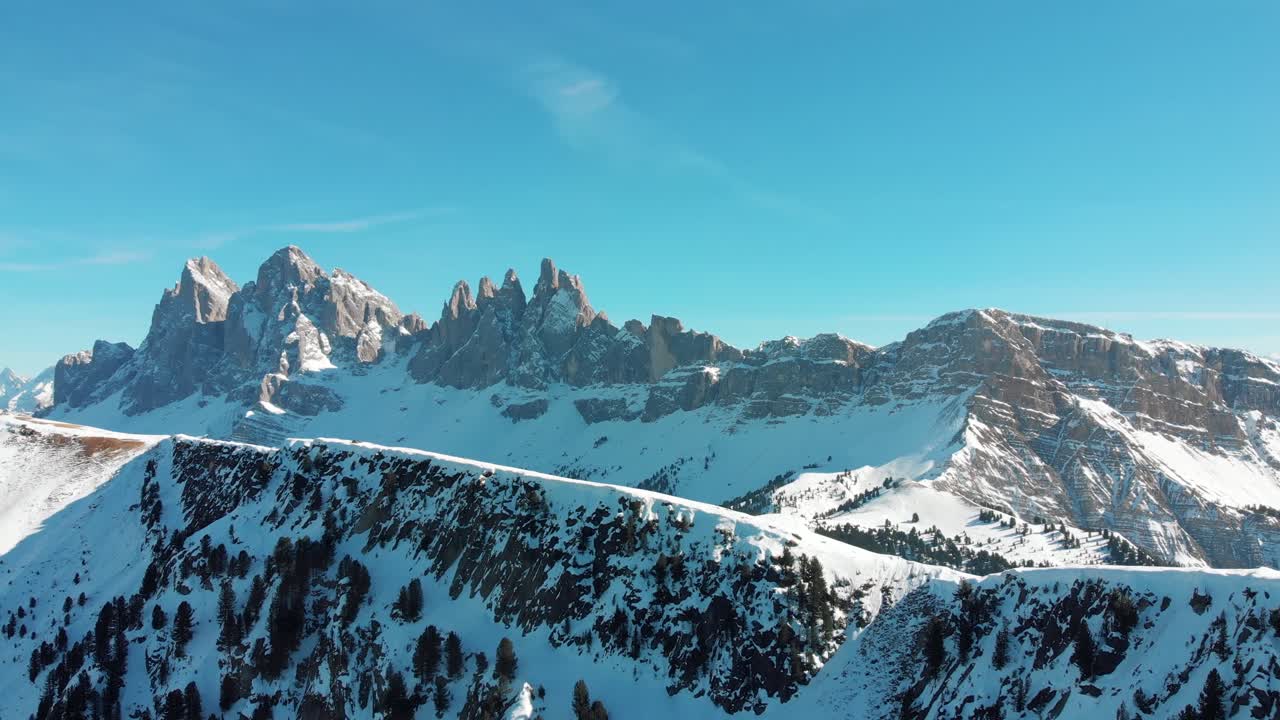 Aerial drone shot of Odle-Dolomites and Seceda during a sunny winter day, South Tyrol, Italy