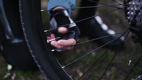 close-up of cap on a bicycle, male hands remove the cap from the tire