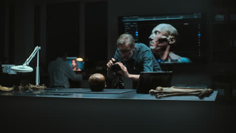 anthropologist examining skull in a laboratory setting