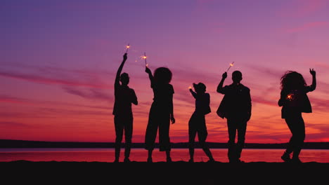 friends celebrating sunset with sparklers