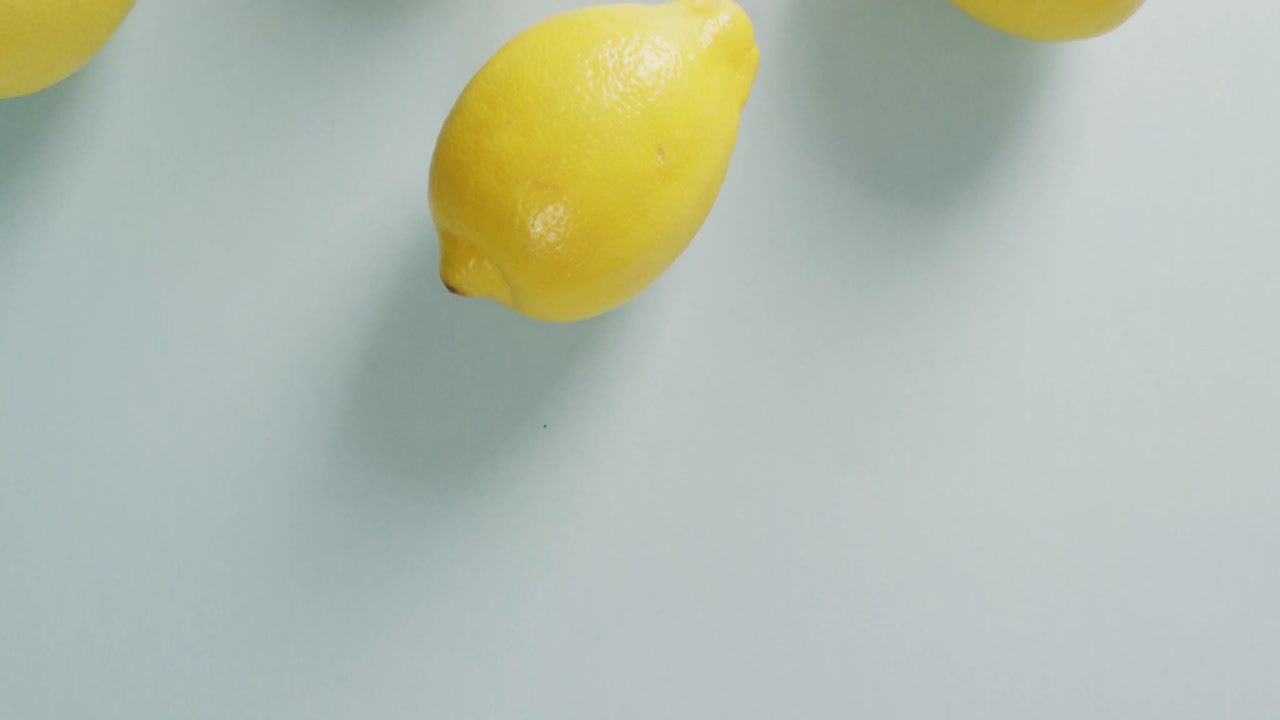 Video of fresh lemons lying on grey background