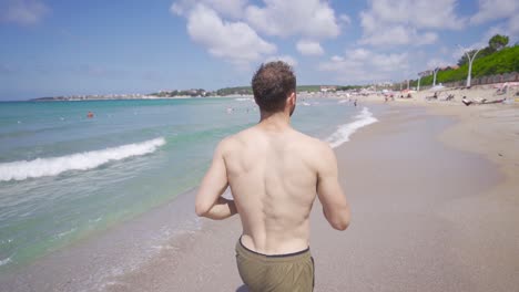 man running in the sea in slow motion.