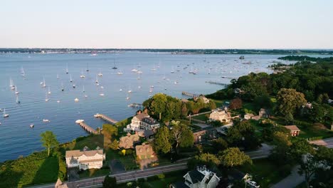 aerial view of waterfront property with sailboats in the bay