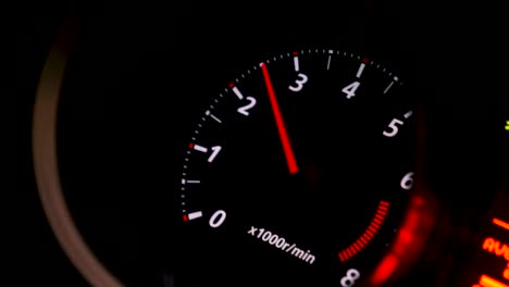 car dashboard tachometer at night