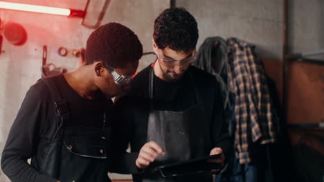 two workers collaborating on a project in a workshop