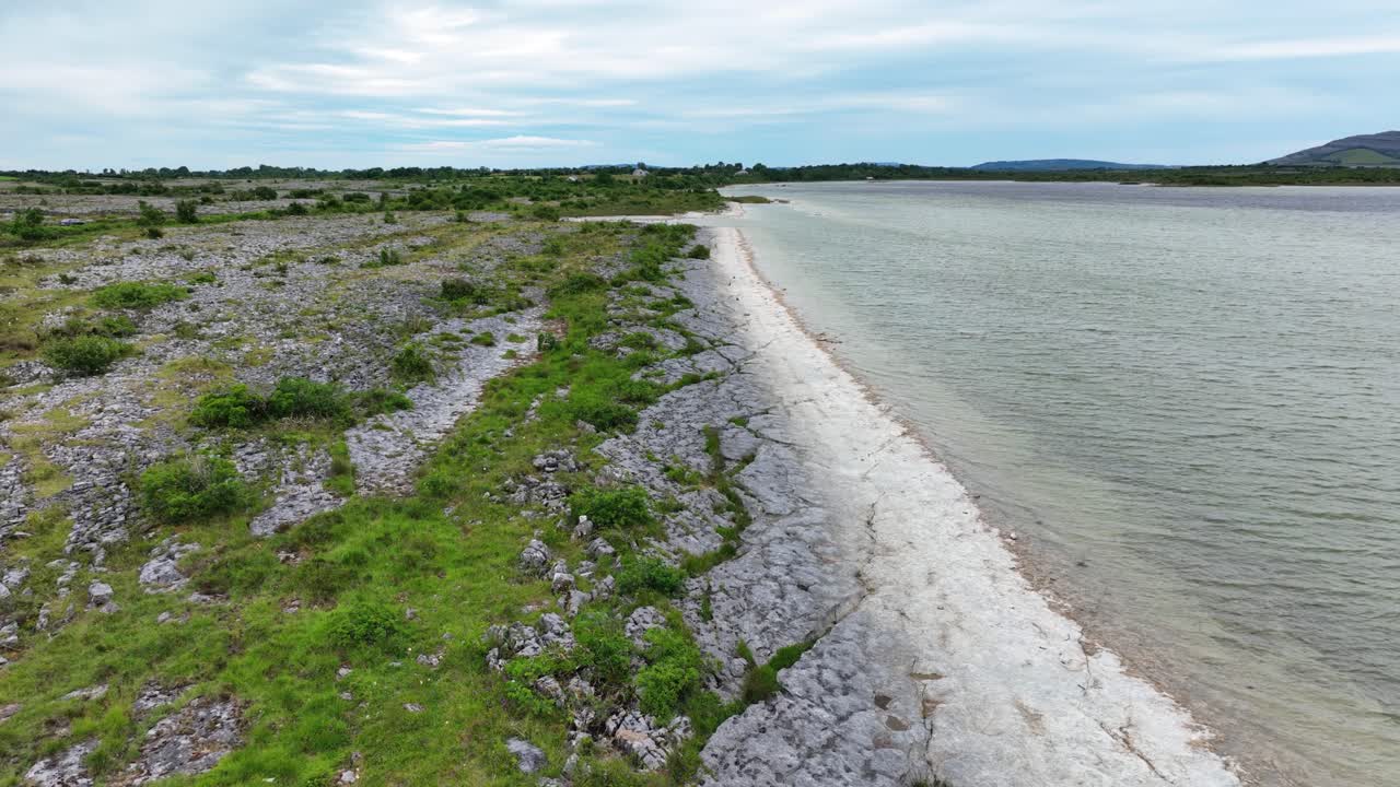 Ireland Epic Landscapes drone flying along edge of fresh water lake The Burren Ireland in summer