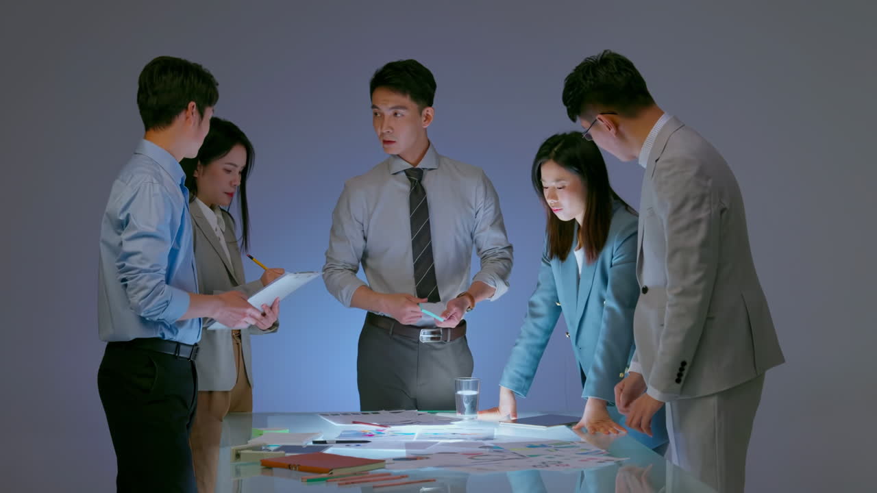 Team of business people working together at office desk, discussions revolving around financial charts, Balance sheet, accounting, taxes, profit to discuss, plan marketing strategy, teamwork concept