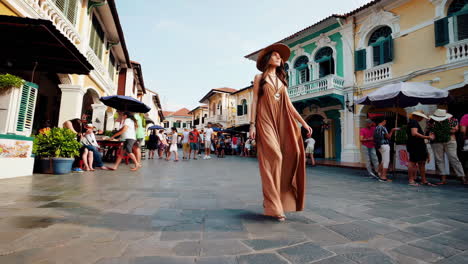 young woman in a hat exploring a bustling street