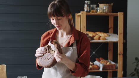 Portrait-of-Happy-Female-Baker-with-Loaf-of-Fresh-Rye-Bread
