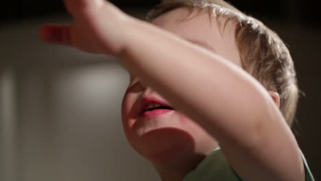 two year old boy blowing soap bubbles