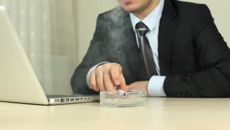 Businessman-Smoking-Cigarette-In-Office-2