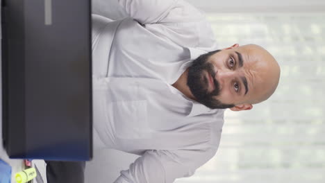 vertical video of home office worker man making negative gesture at camera.