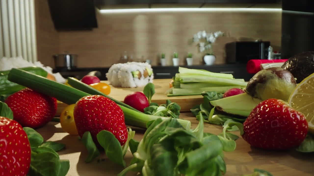 Fresh Ingredients and Sushi Roll Preparation in a Modern Kitchen