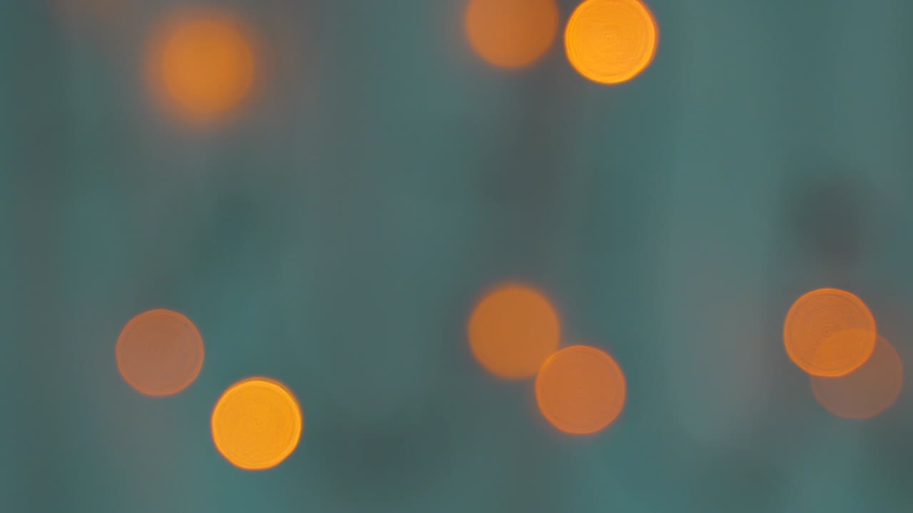 Abstract background. Blur Christmas tree lights bokeh background. Blinking Christmas tree lights twinkling. Defocused bubbles background. Blurred glowing bokeh lights. December party decoration.