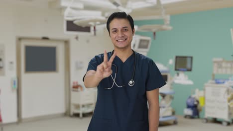 Happy-Indian-doctor-showing-victory-sign