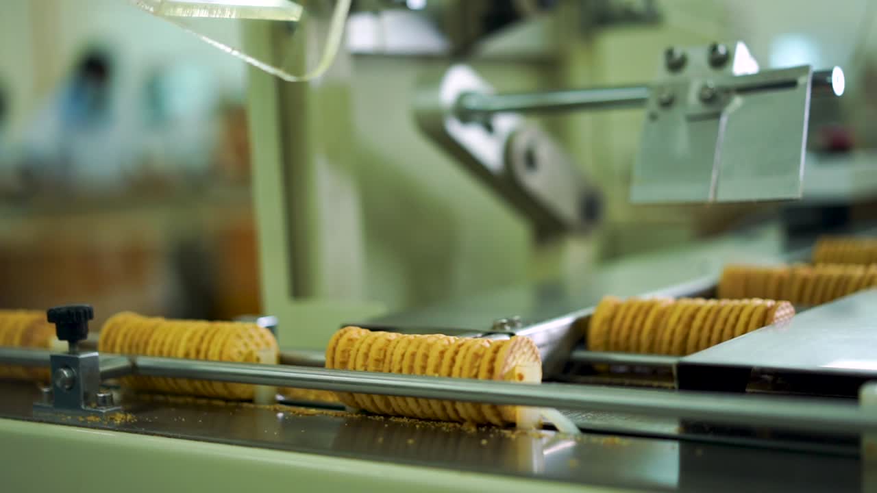 Packs of biscuits in the production line of a factory with robots and technology
