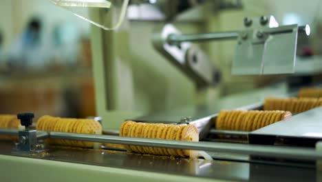 packs of biscuits in the production line of a factory with robots and technology