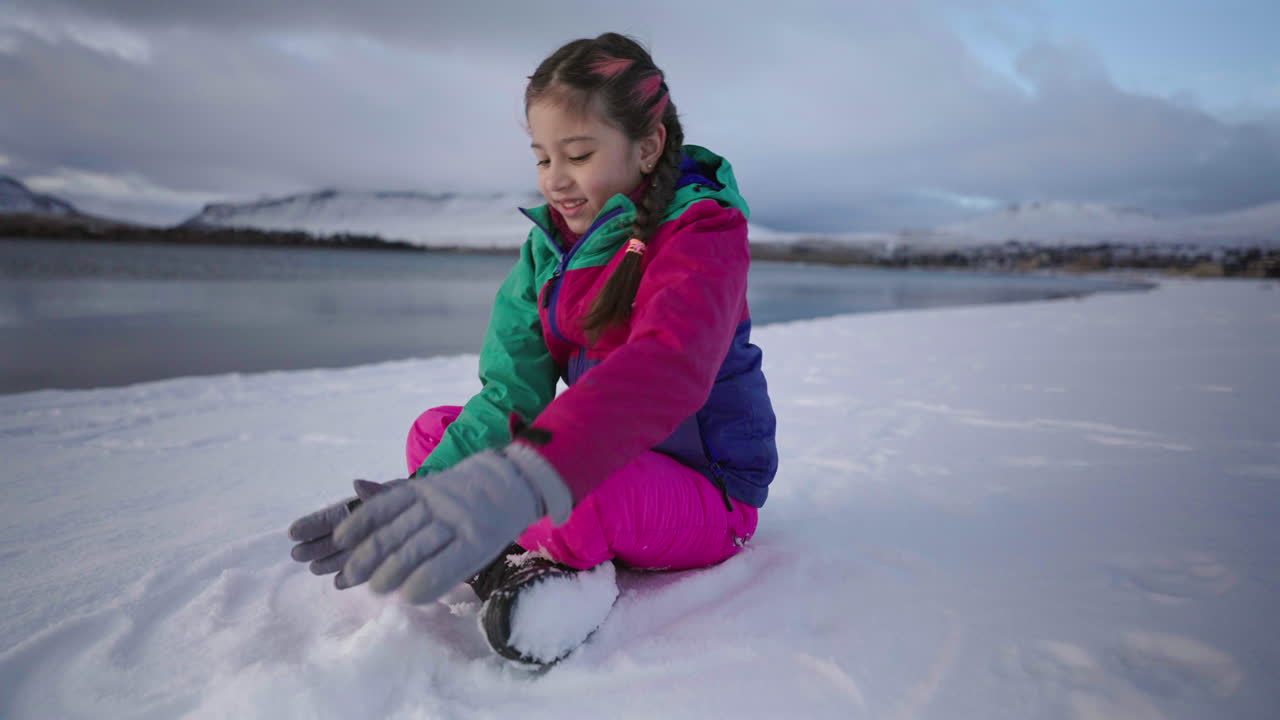 Girl enjoying her time and playing in snowy mountains