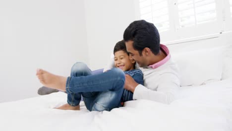 Father-and-son-playing-on-bed