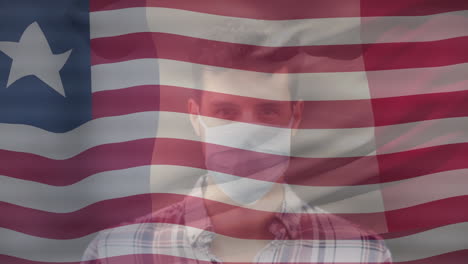 animación de la bandera de liberia sobre un hombre biracial con máscara facial