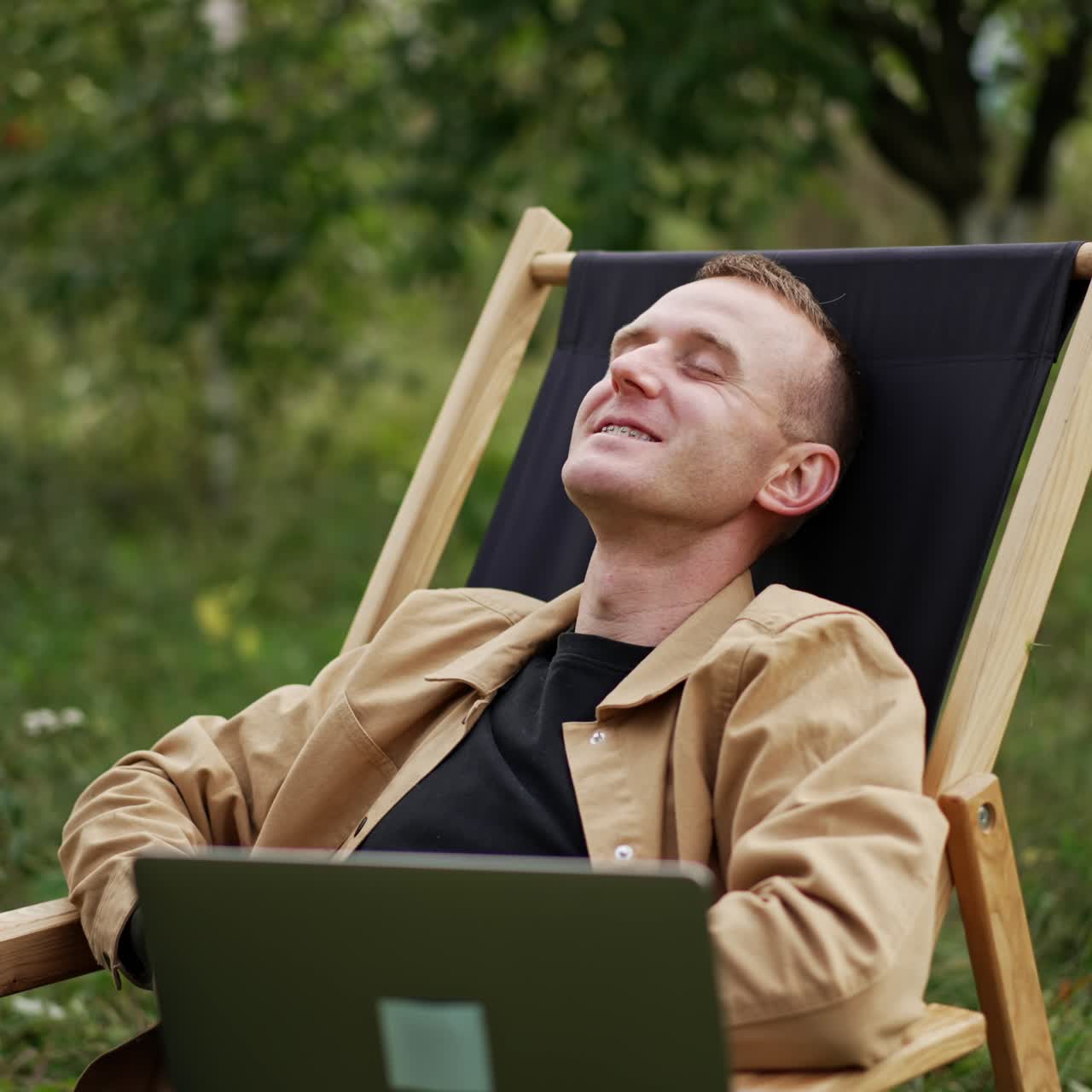 Mid aged freelancing specialist finishing online chat on his laptop. Man says goodbye and leans back relaxing in his chair. Freelancer opens his eyes and sees something bad happens on the screen