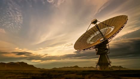 a wide-angle shot of a large satellite dish in a desert at sunset, capturing a sci-fi video concept