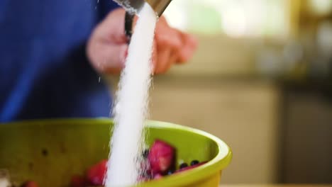 close up pouring sugar into a bowl for pie filling