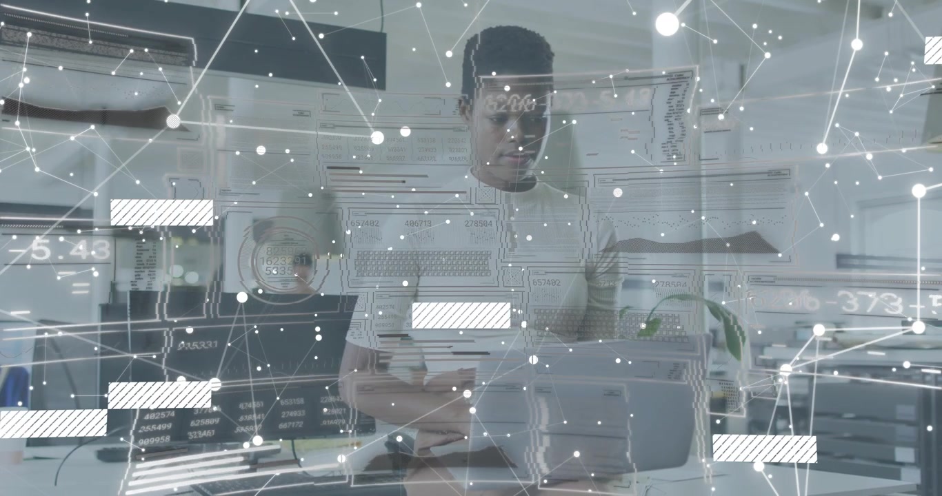 Desk worker typing on laptop and initiating node overlay scrolling blocks visualizing data network