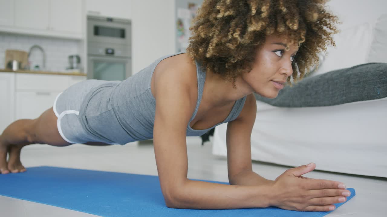 Beautiful woman training abs at home