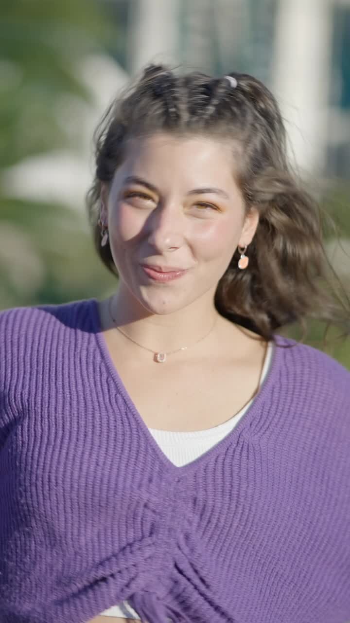Happy Young Woman Enjoying a Lollipop on a Breezy Day