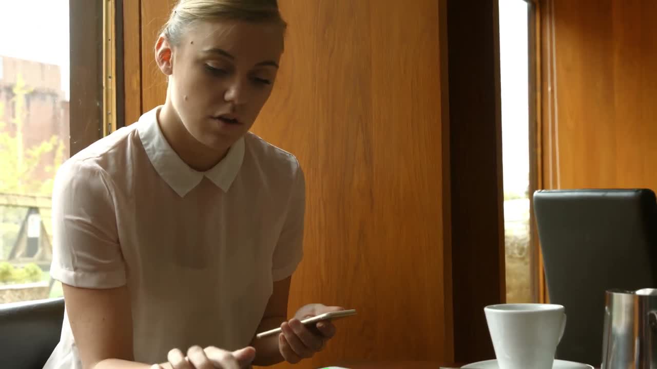 Pretty woman working on smartphone and tablet