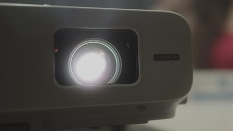 pupil at school watching film on laser beamer,close up shot of light. film projector in old vintage school.