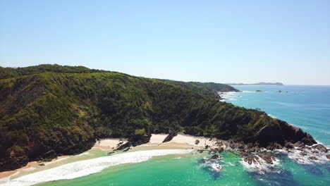 aerial: drone shot rising higher to reveal more of the beautiful new south wales coastline, near byron bay australia