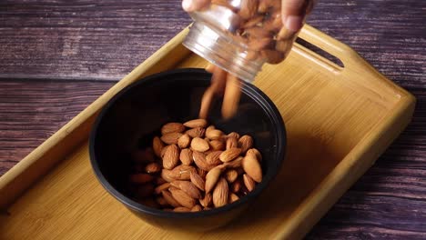 pouring almonds into a bowl