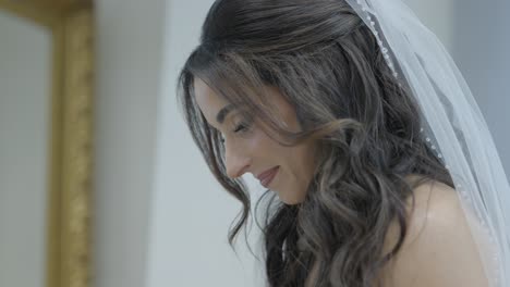 bride reacting to video message from groom before wedding