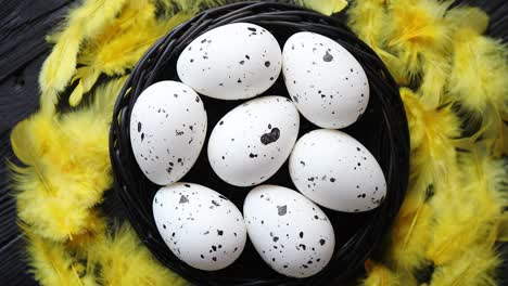 whole chicken eggs in a nest on a black rustic wooden background  easter symbols