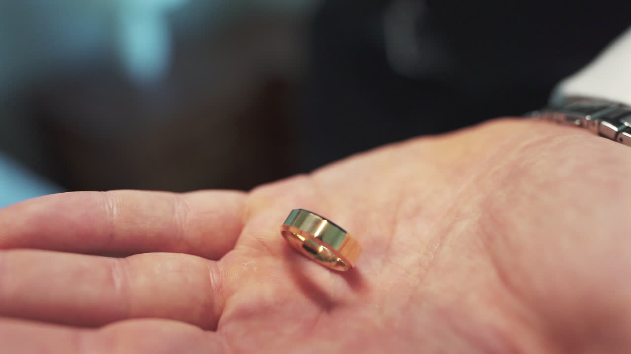 Engagement rings falling in open hand, vows, bond, and luxury wedding details