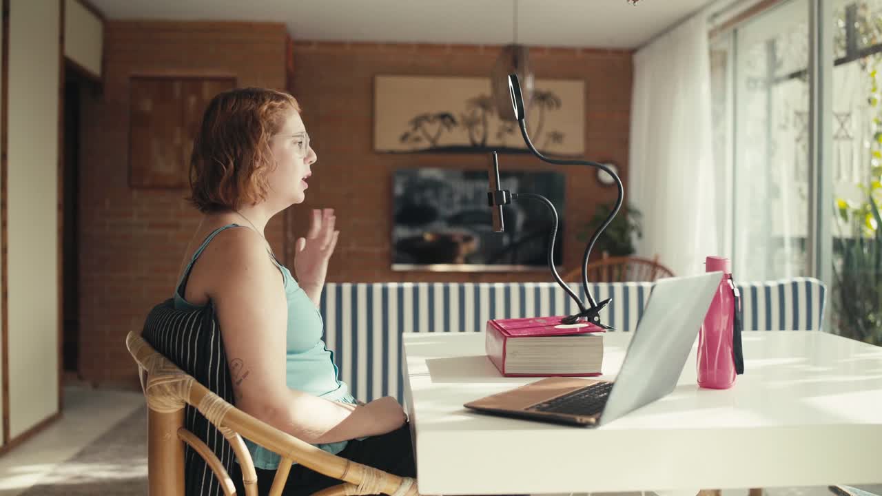 A young woman recording online video content using her smartphone