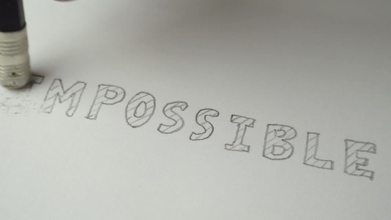 Changing the word impossible to possible. Impossible word gets the ''im'' removed to make it possible. Pencil erase it to possible. Closeup