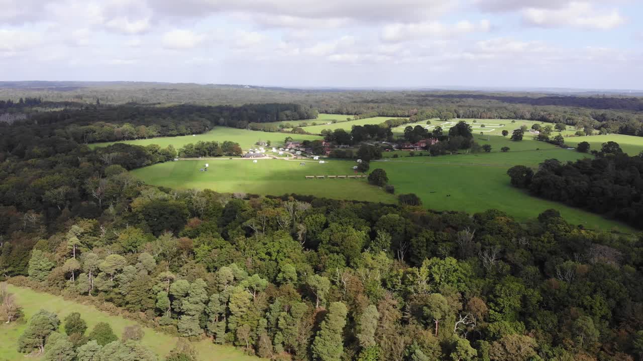 Capturing breathtaking aerial views of New Forest National Park, showcasing its lush meadows, dense trees, and expansive woodlands. push forward
