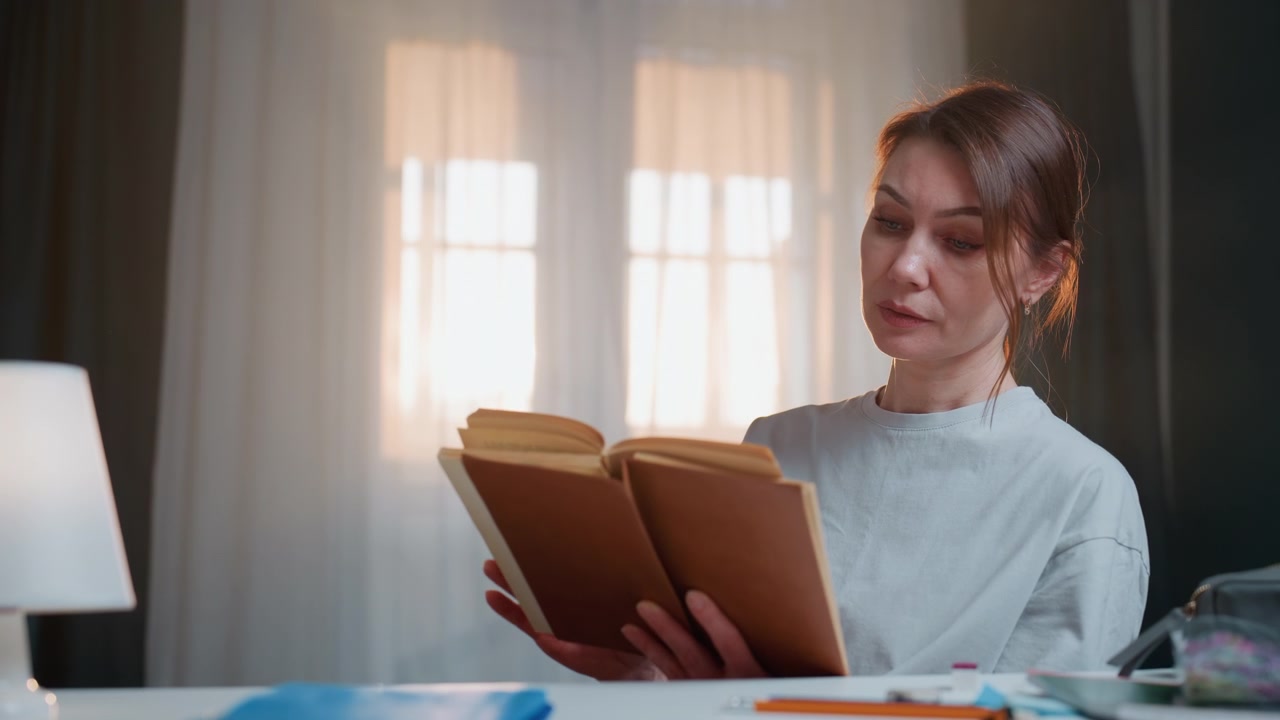 Caucasian woman tutor reading book by lamp, cozy home study with window light, annotating grammar notes, focused expression, neat desk with notebook and pen, warm morning atmosphere