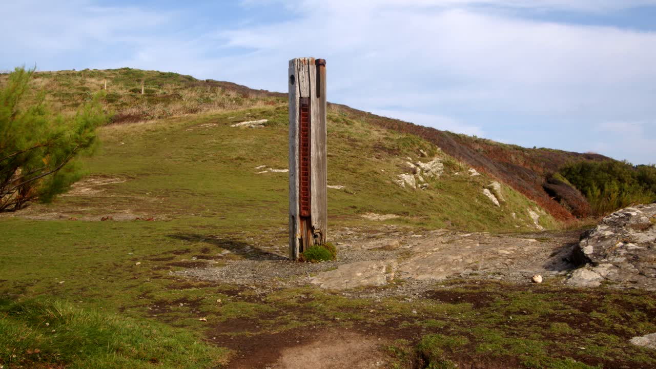 extra wide shot of HMS Warspite monument with Bessy's Cove,The Enys in background