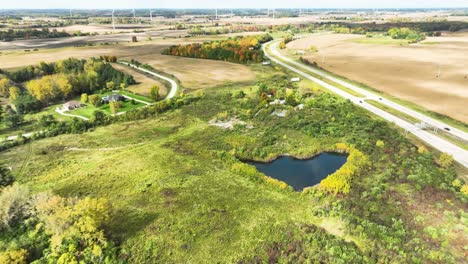 A-small-pond-in-the-distance-above-the-outskirts-of-Alma,-Michigan