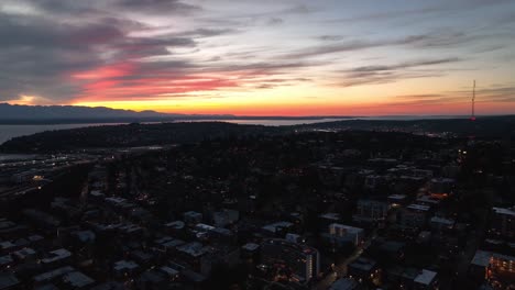 Lowering-aerial-shot-of-the-sun-setting-over-Seattle's-Queen-Anne-neighborhood