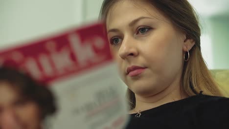 una chica bonita leyendo la revista de cerca