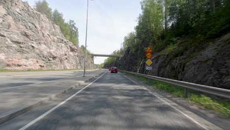 vehicles are in motion, gracefully moving along the road, adding a dynamic element to the landscape