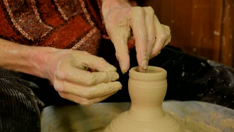 professional male potter working in workshop