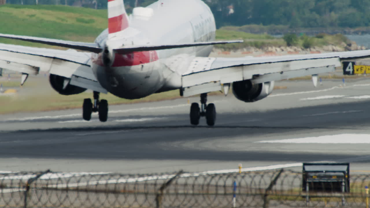 Commercial Jet Touches Down on Runway with Puff of Smoke from Tires at LaGuardia Airport in New York City