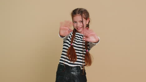 Young cute school girl kid smiling friendly gesturing hello or goodbye welcoming waving hands