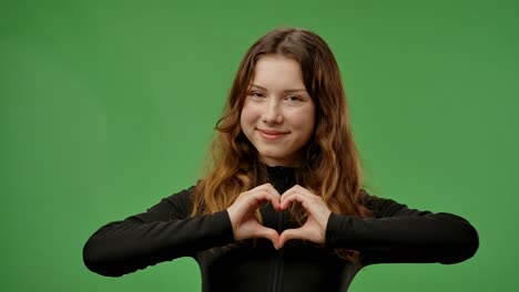 teenager making heart shape with hands